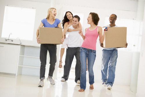 Staff loading a van safely with boxes and furniture