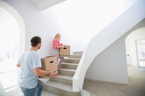 Relocation crew handling desks and furniture in a Crooklog workspace